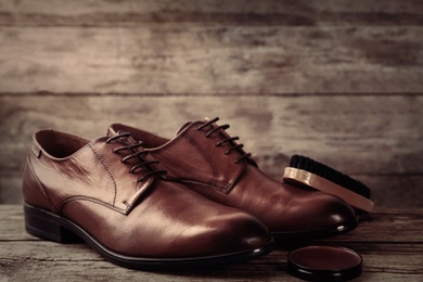 Image of Shoe care accessories and footwear on wooden background