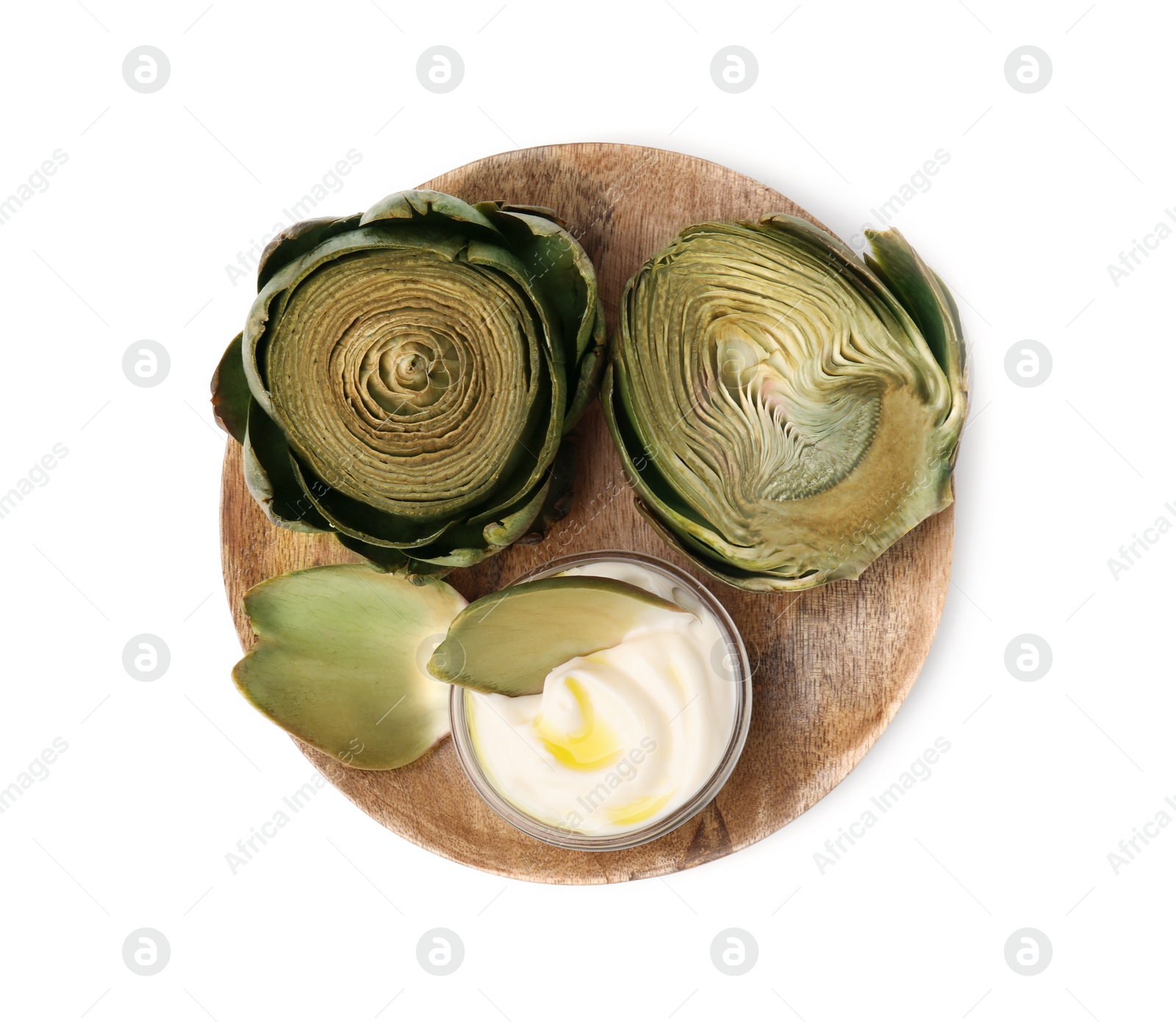 Photo of Delicious cooked artichokes with tasty sauce isolated on white, top view