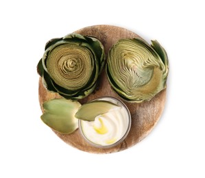 Delicious cooked artichokes with tasty sauce isolated on white, top view