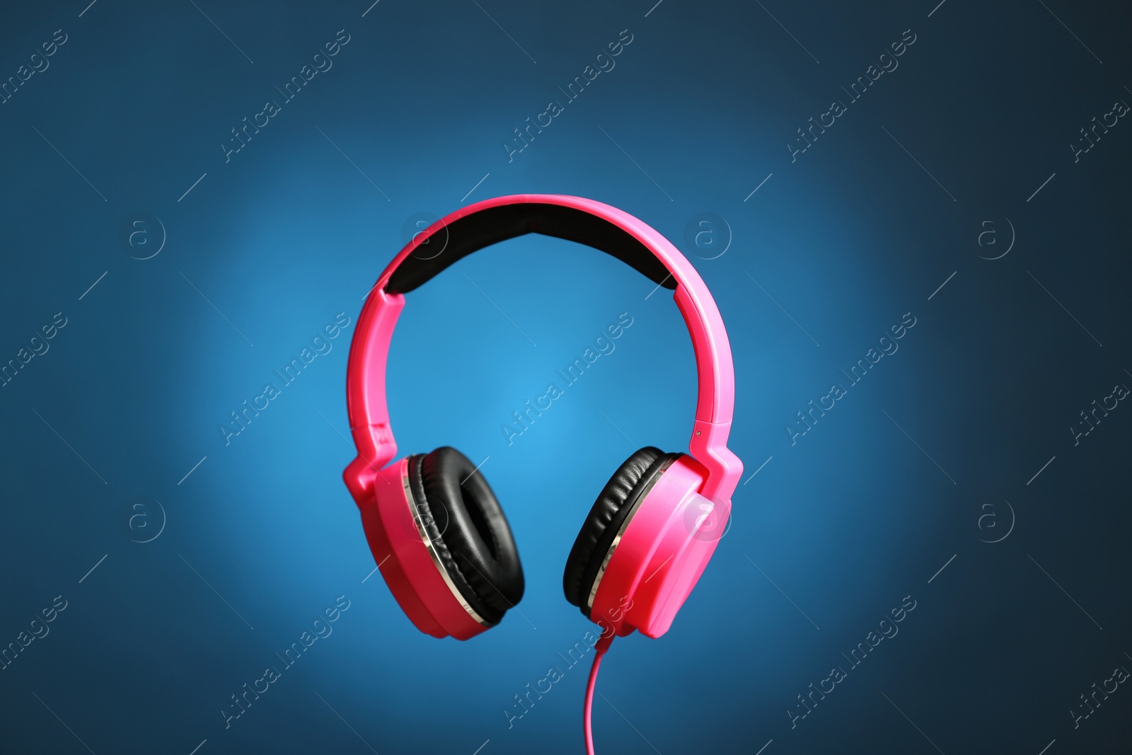 Photo of Stylish headphones with pads on color background