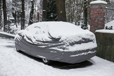 Photo of Car covered with snow outdoors on winter day