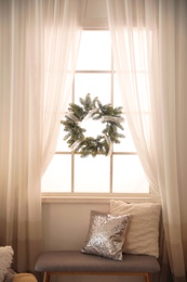 Photo of Stylish Christmas interior with decorative wreath