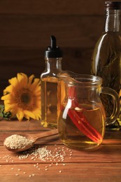 Photo of Different cooking oils and ingredients on wooden table