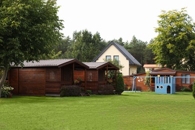 Beautiful wooden beach houses and green trees outdoors