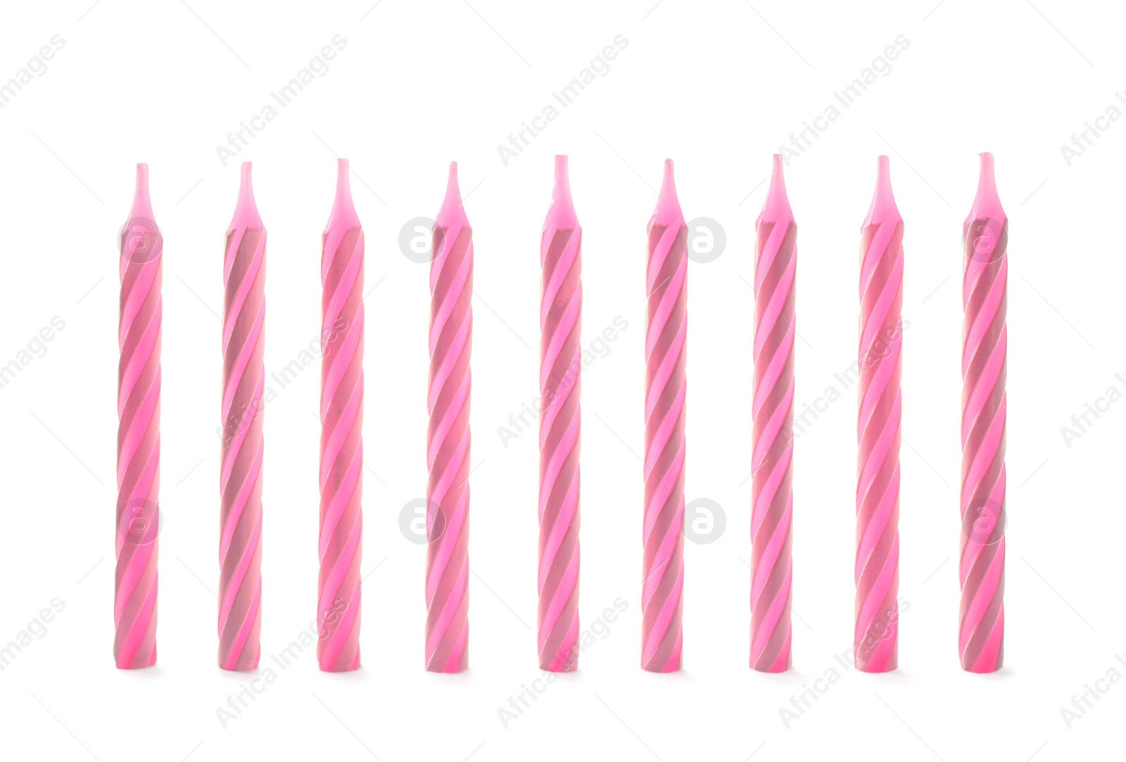 Photo of Pink striped birthday candles isolated on white