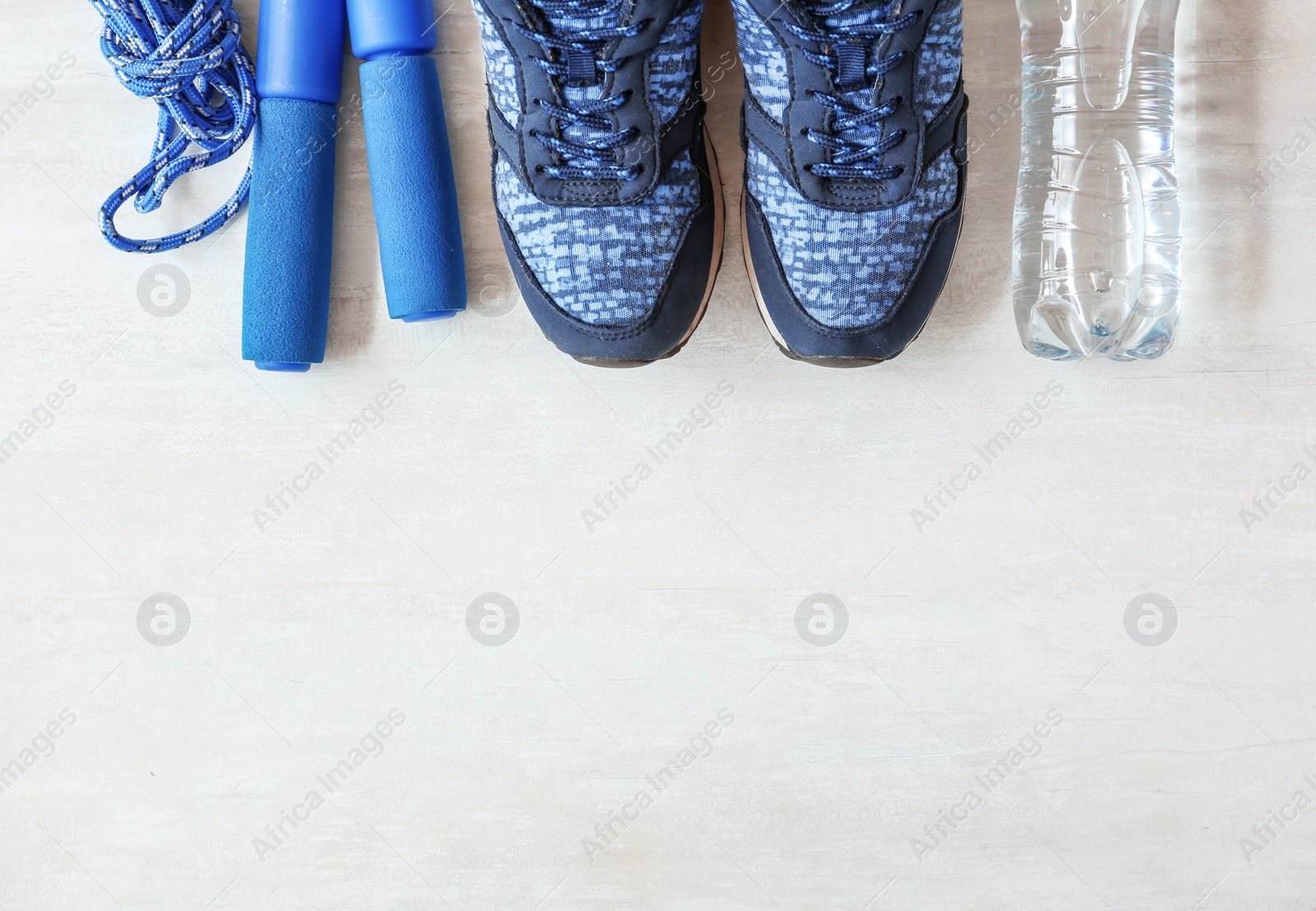 Photo of Flat lay composition with fitness equipment and space for text on gray background