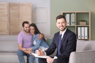 Photo of Professional psychologist and young couple in office