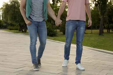 Photo of Gay couple walking outdoors on sunny day, closeup