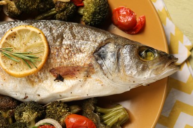 Photo of Delicious baked fish and vegetables on table, top view