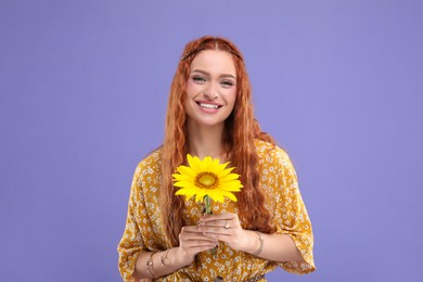 Photo of Beautiful young hippie woman with sunflower on violet background