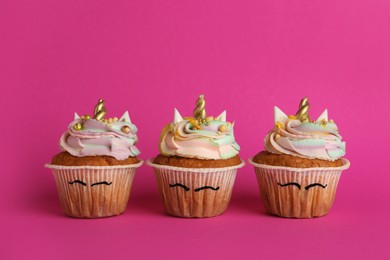 Cute sweet unicorn cupcakes on pink background