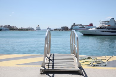 Photo of Modern ship gangway on pier in seaport