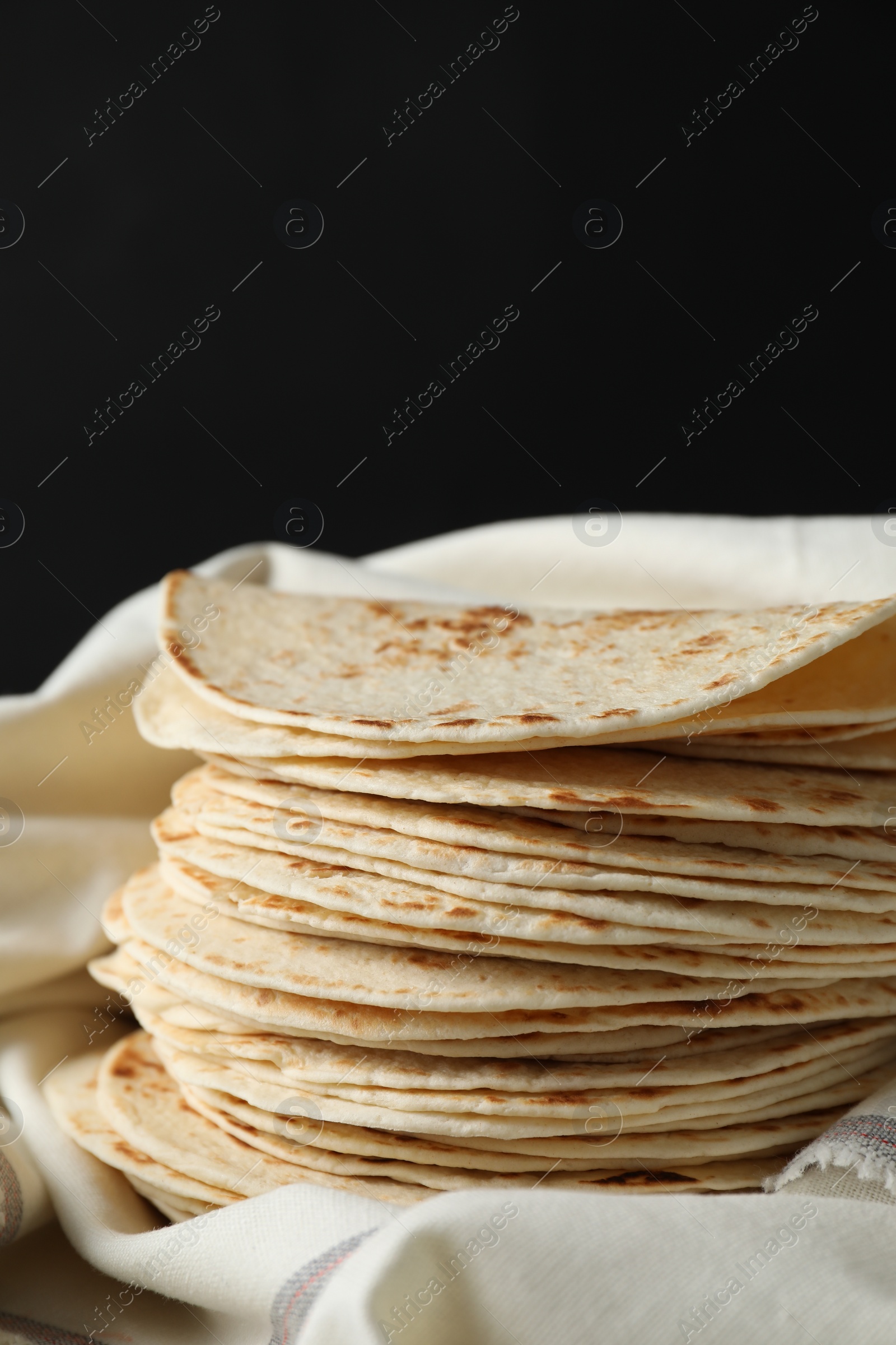 Photo of Stack of tasty homemade tortillas on table