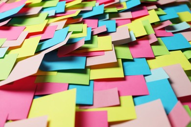 Photo of Colorful paper notes as background, closeup view