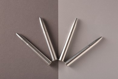 Photo of Many metal bullets on color background, flat lay