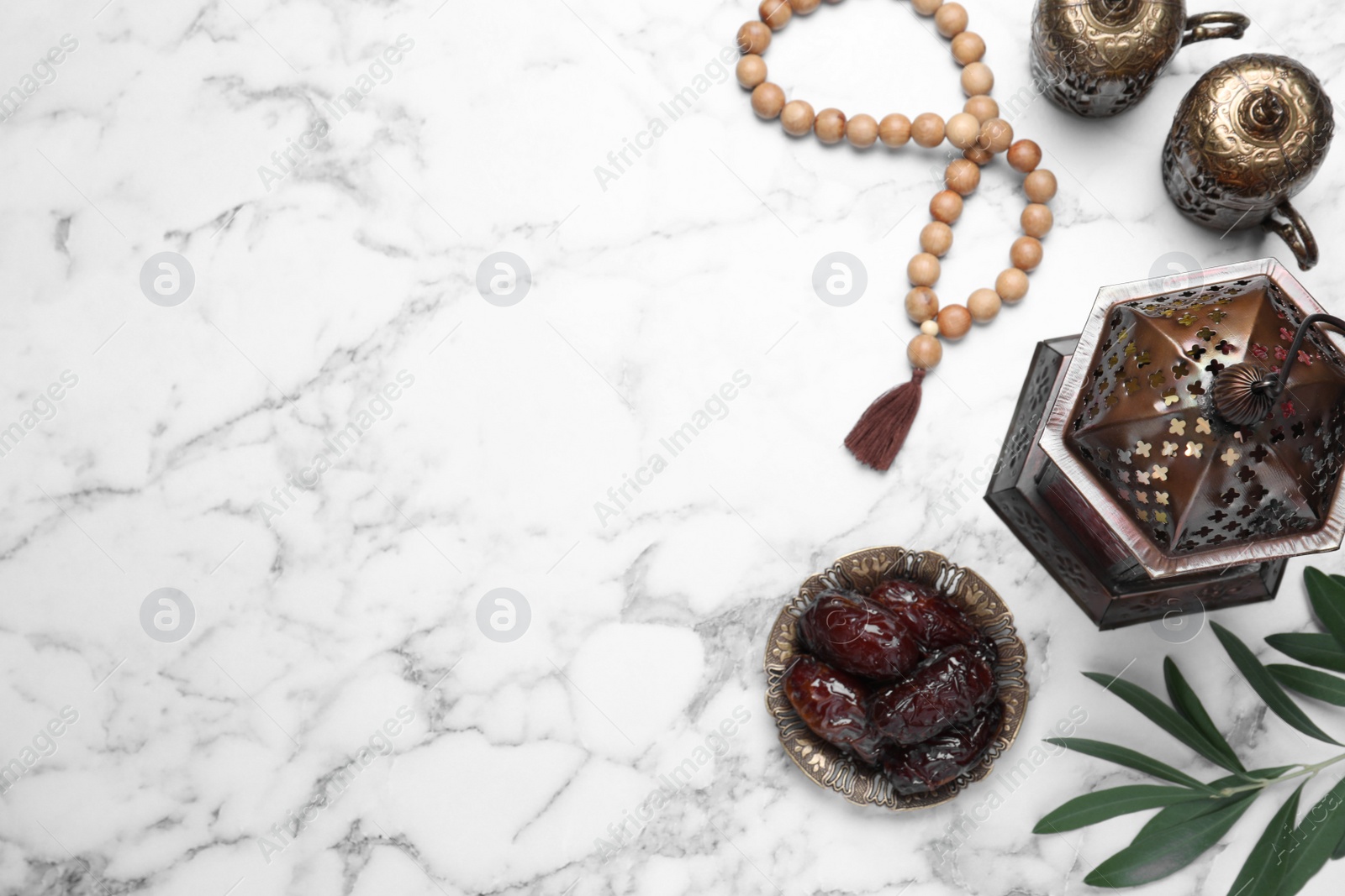 Photo of Flat lay composition with Arabic lantern on white marble table . Space for text