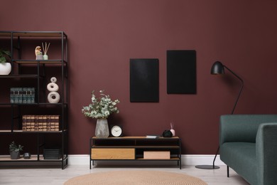Photo of Elegant room interior with wooden cabinet, shelving unit and floor lamp near brown wall