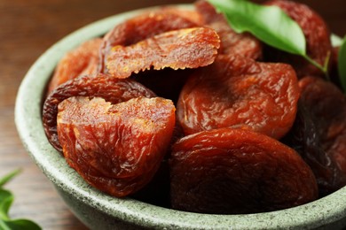 Photo of Closeup view of tasty apricots in bowl. Dried fruits