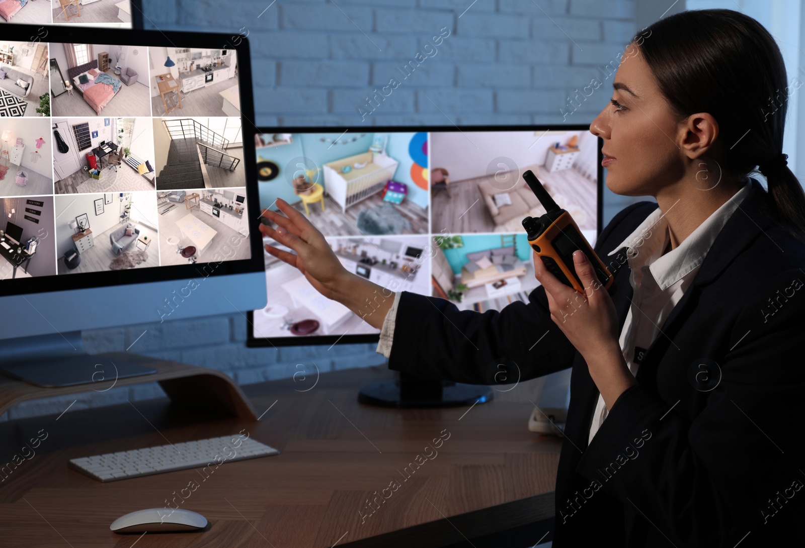 Photo of Female security guard with portable transmitter at workplace