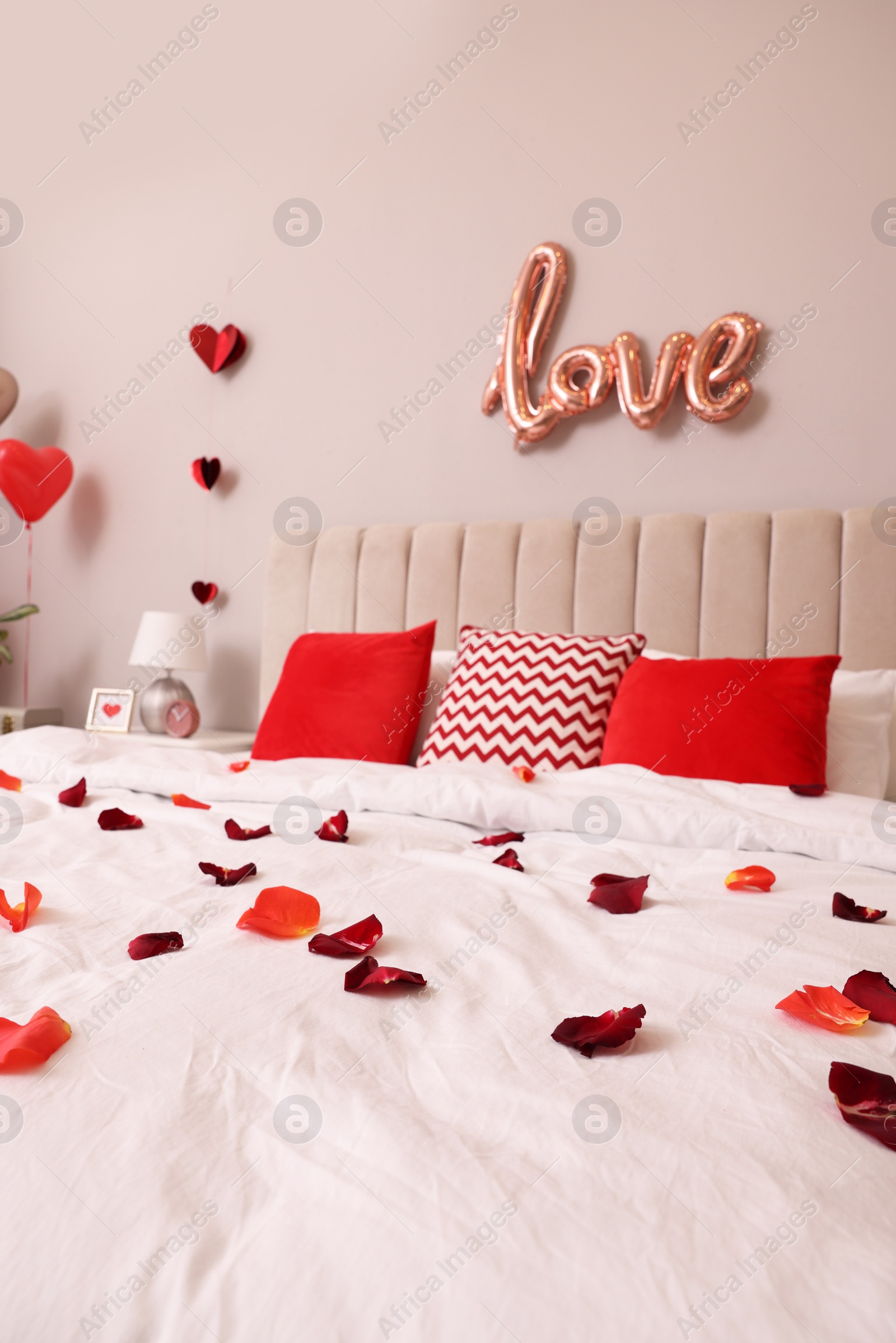 Photo of Cozy bedroom decorated for Valentine Day. Interior design