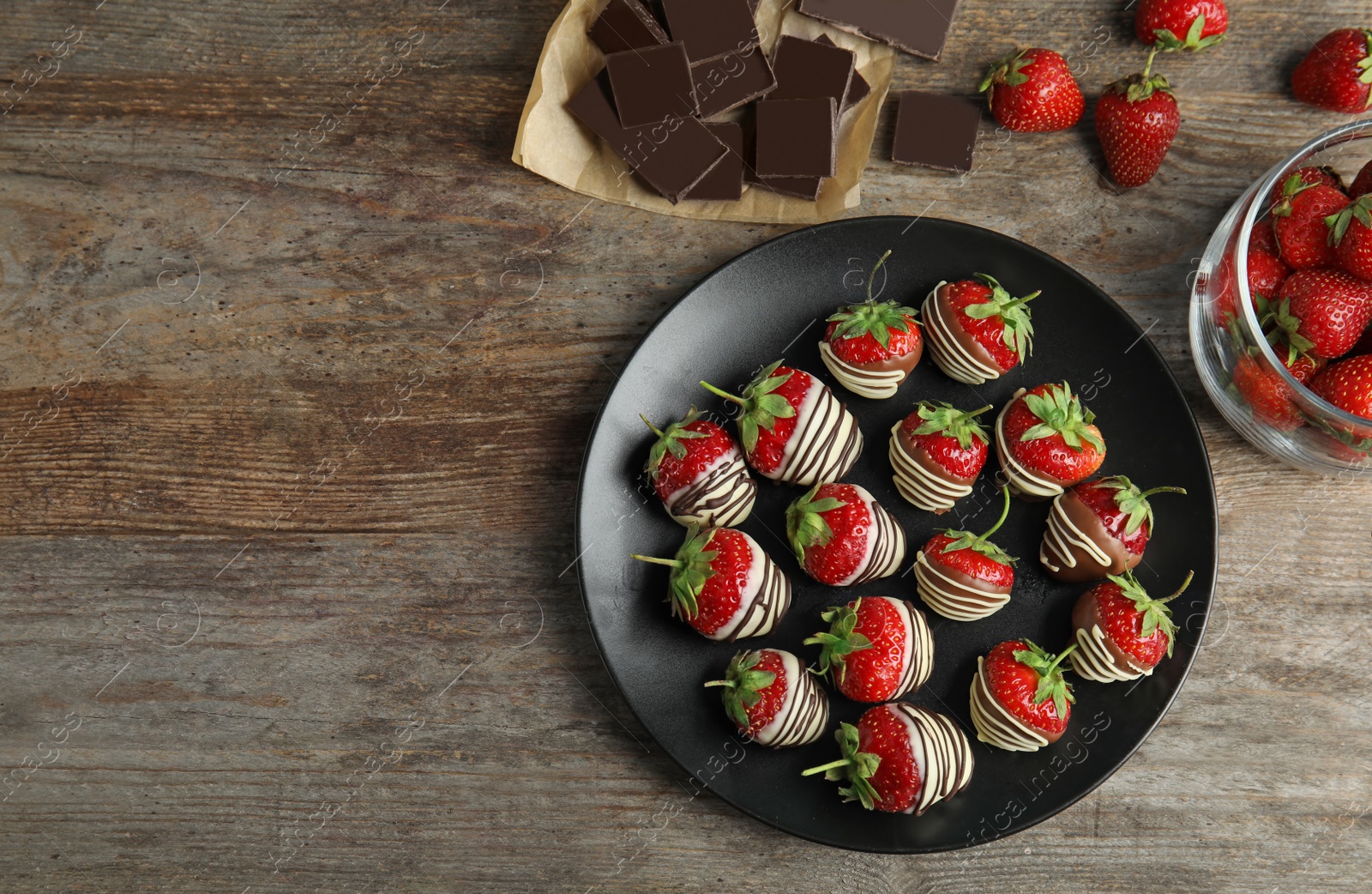 Photo of Flat lay composition with chocolate covered strawberries on wooden background