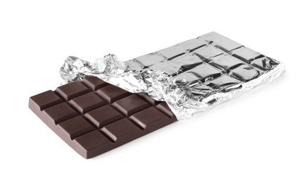 Photo of Delicious dark chocolate bar wrapped in foil isolated on white