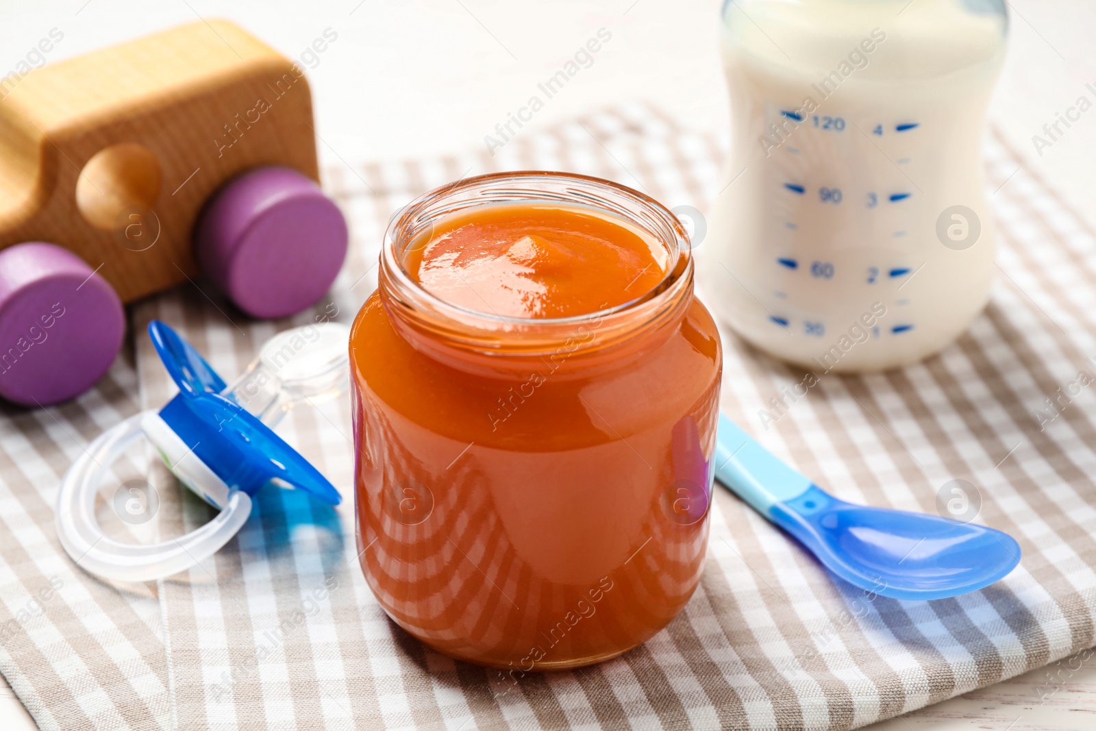 Photo of Healthy baby food in jar on table, closeup