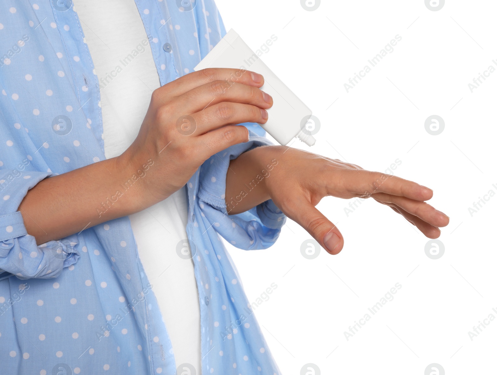 Photo of Woman applying cream on her hand against white background, closeup