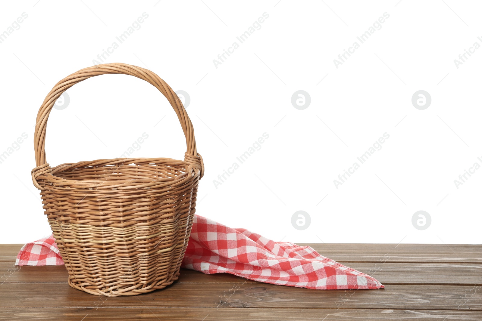 Photo of Empty wicker basket and cloth on wooden table against white background, space for text. Easter holiday