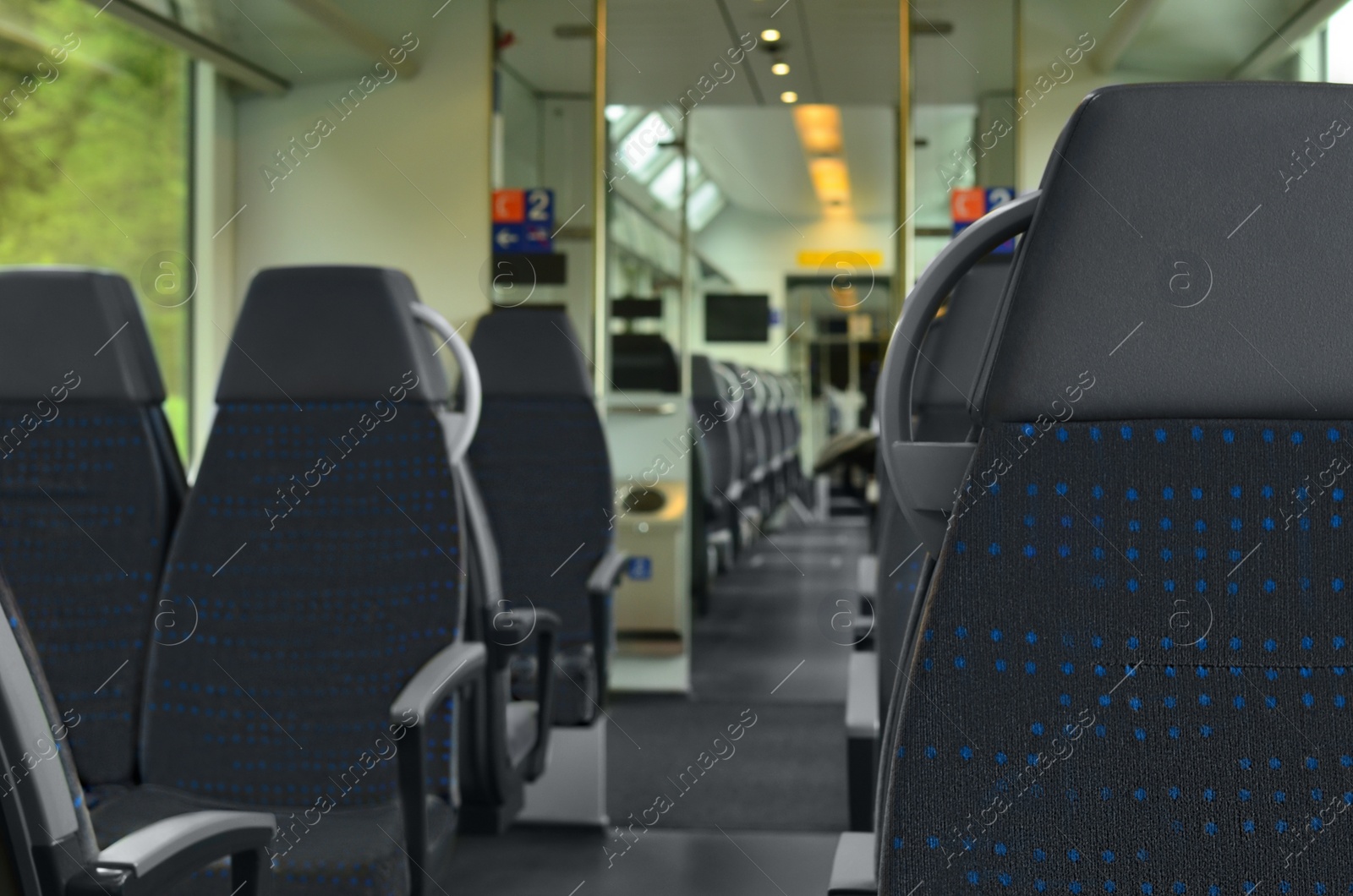 Photo of Comfortable seats in empty modern passenger train, selective focus