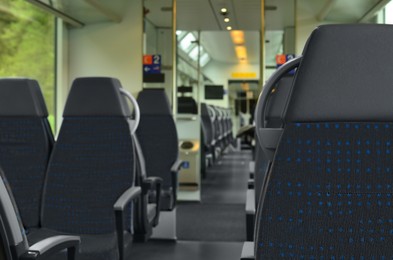 Photo of Comfortable seats in empty modern passenger train, selective focus