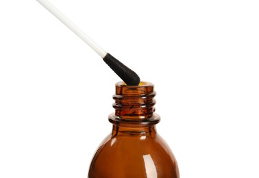 Photo of Bottle of medical iodine and cotton bud on white background, closeup