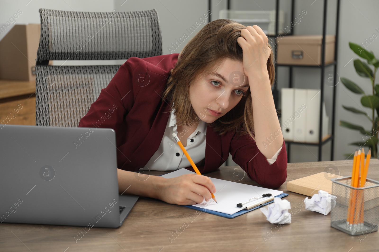 Photo of Sad businesswoman working at wooden table in office