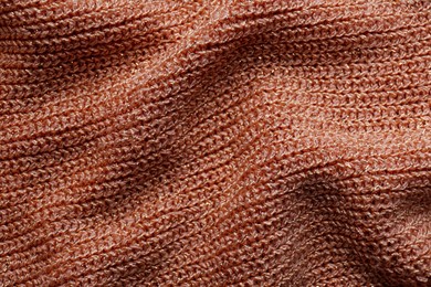 Photo of Brown knitted fabric as background, top view