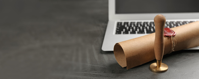 Image of Notary's public pen and sealed document near laptop on grey stone table, space for text. Banner design