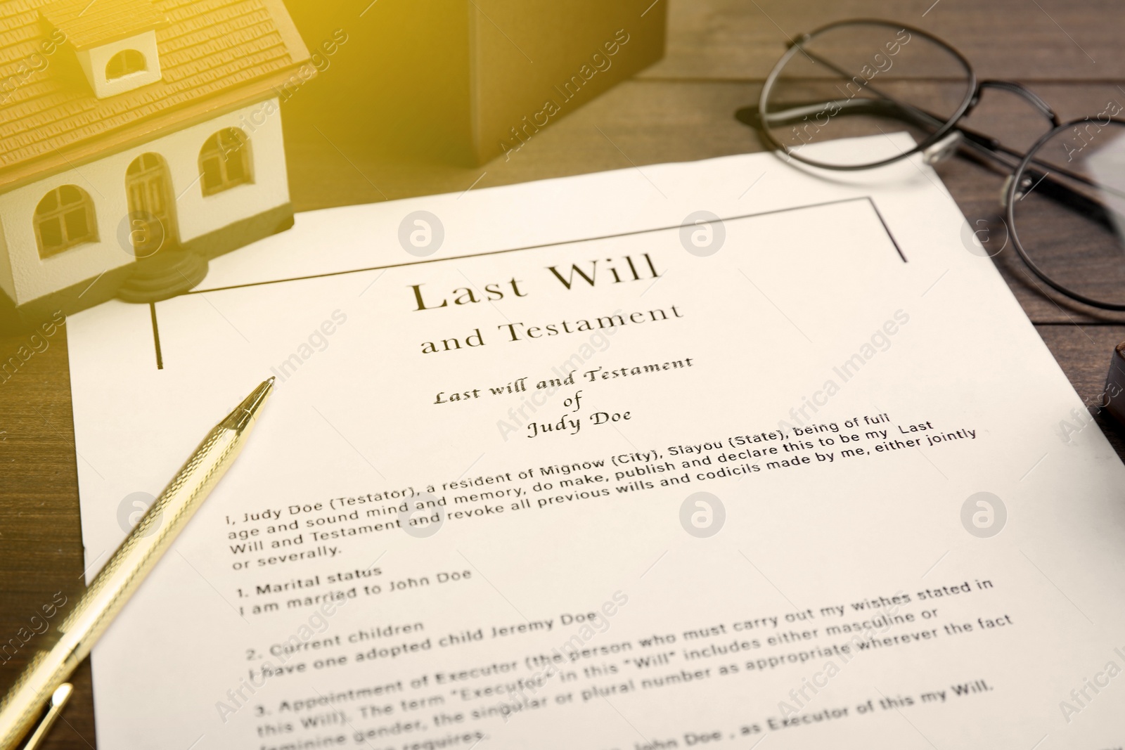 Image of Last Will and Testament, house model, glasses and pen on table, closeup