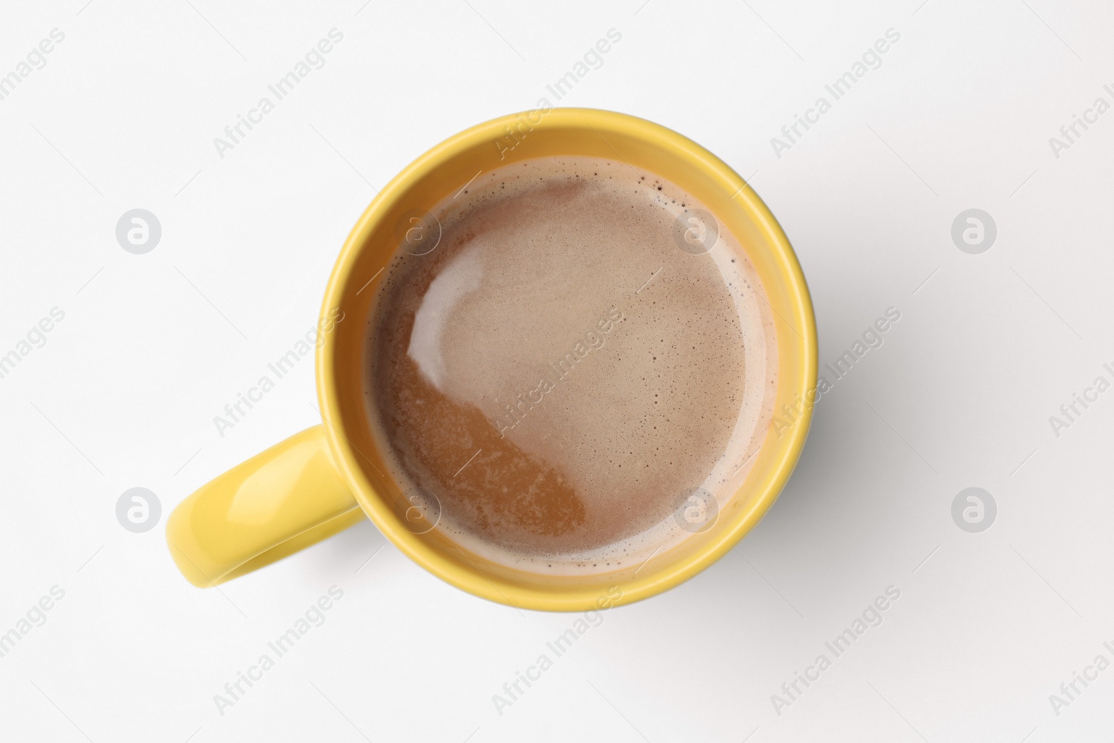 Photo of Yellow mug of freshly brewed hot coffee on white background, top view