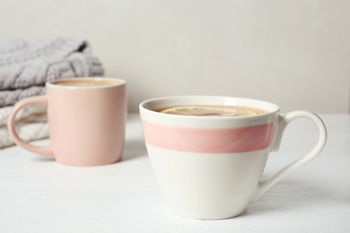 Photo of Cup of hot tea with lemon on white table