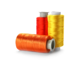 Photo of Color sewing threads on white background