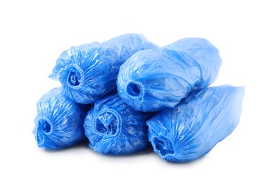 Photo of Many rolled blue shoe covers isolated on white