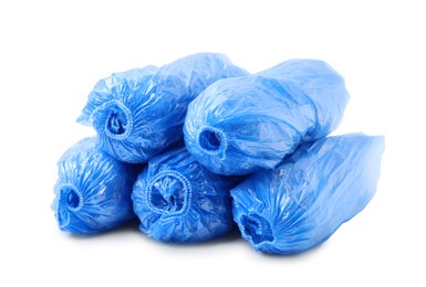 Many rolled blue shoe covers isolated on white