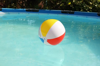 Inflatable ball on water in above ground swimming pool outdoors