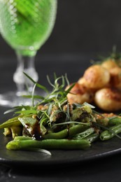 Photo of Tasty salad with tarragon served on table, closeup