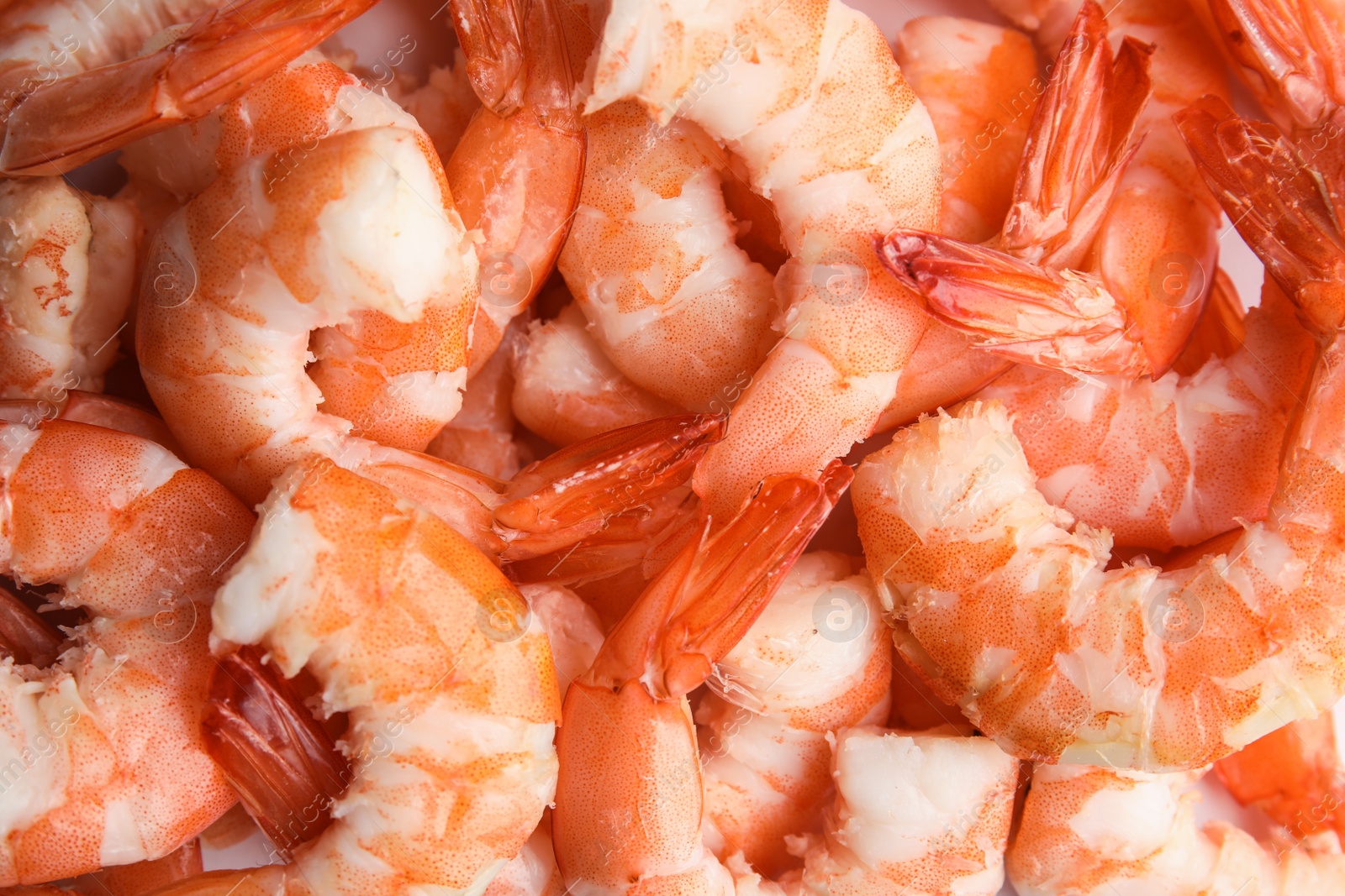 Photo of Pile of delicious peeled shrimps as background, closeup