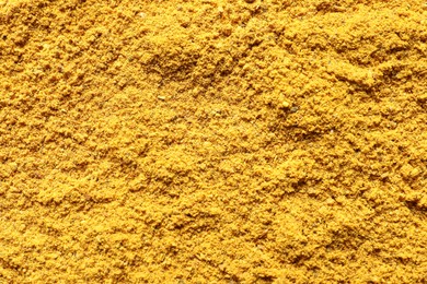 Photo of Dry curry powder as background, top view