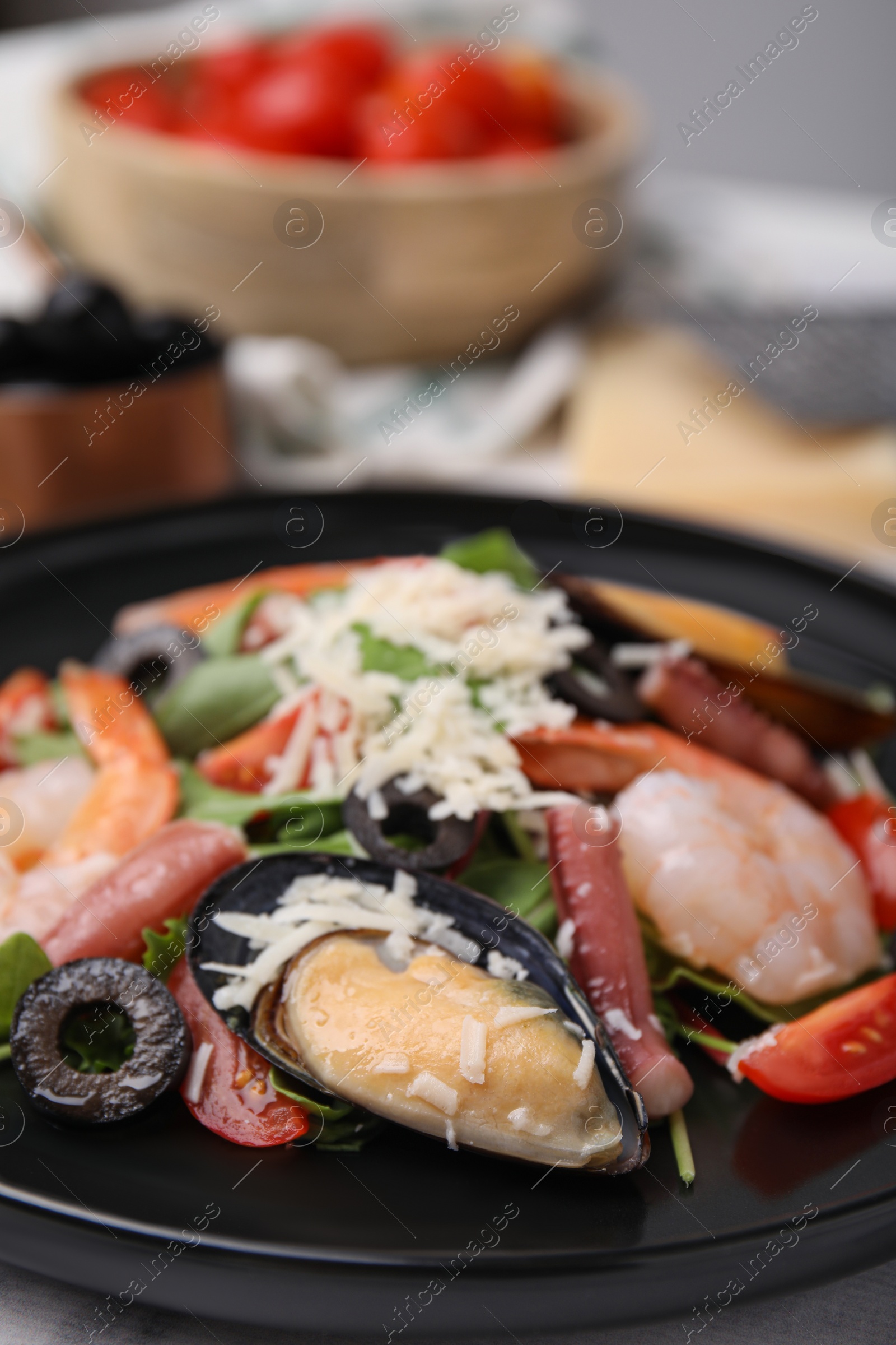 Photo of Plate of delicious salad with seafood, closeup view