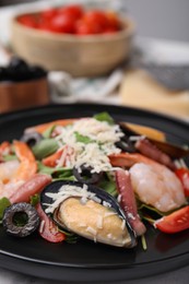 Photo of Plate of delicious salad with seafood, closeup view
