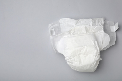 Photo of Baby diaper on light grey background, top view. Space for text