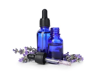 Photo of Bottles with natural lavender oil, flowers and dropper on white background