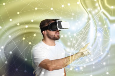 Image of Innovation idea. Man using VR headset. Lights and connected lines around him symbolizing digital reality